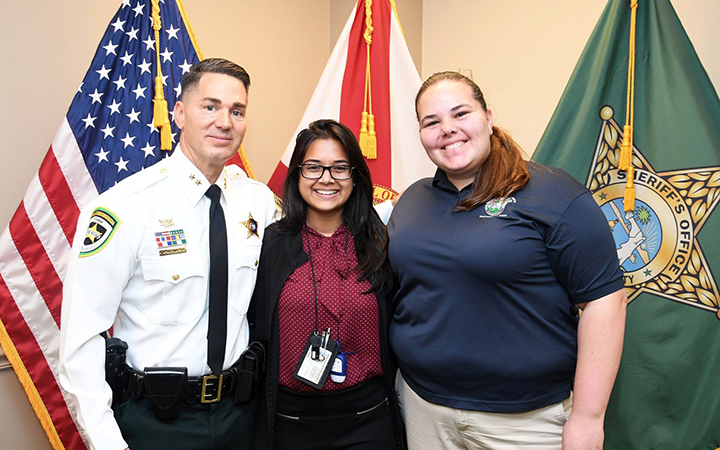 UT student takes a photo with Hillsborough County Sheriff Chad Chronister as part of her internship.