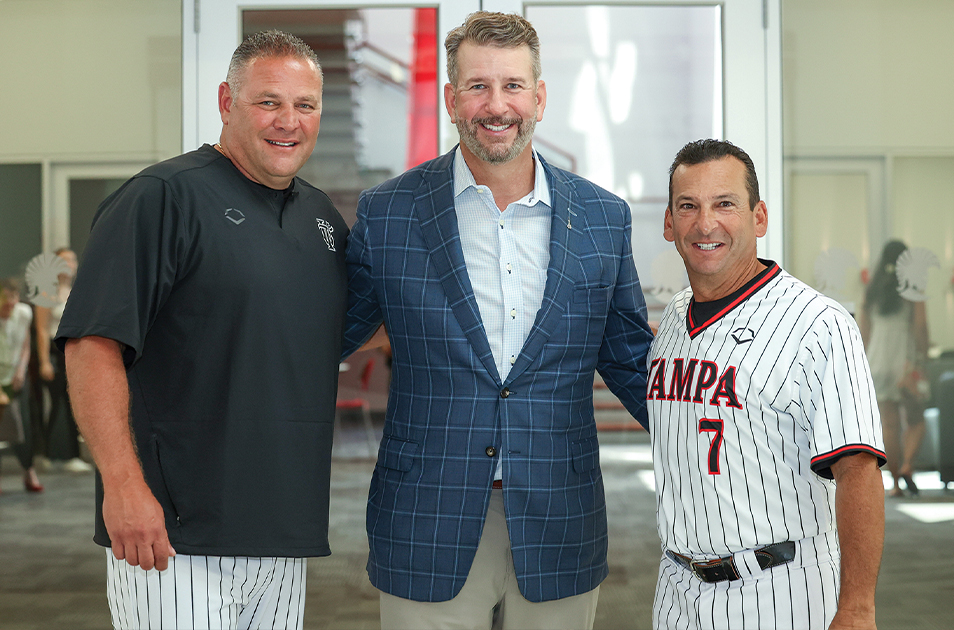 Baseball coaches Sam Militello ’02, left, and Joe Urso ’92 flank Trustee Stephen H. Mauldin ’90 at a ceremony in the study lounge. Photo by Jessica Leigh