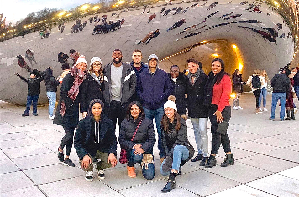 A group of Admissions ambassadors in front of a sculpture in Chicago.