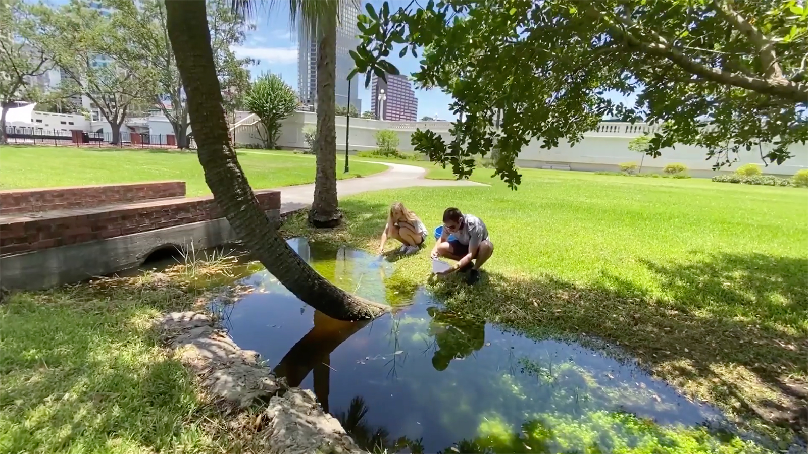 Two students testing water by the Hillsborough River.