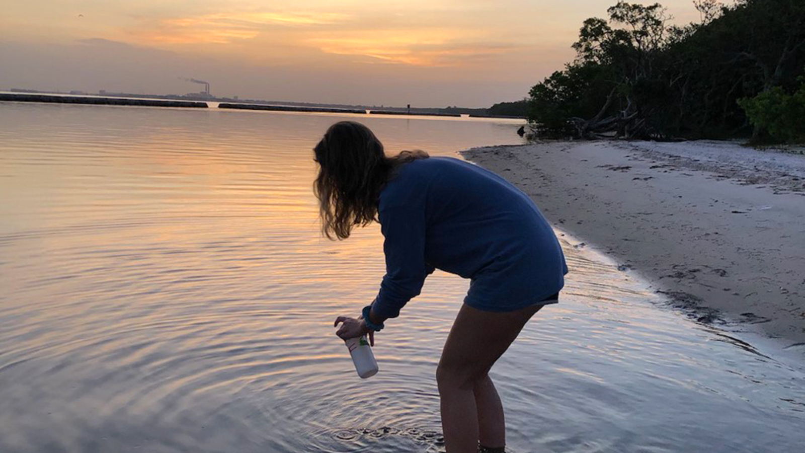 Haley Kudzmas '21 taking a water sample at Gandy Beach