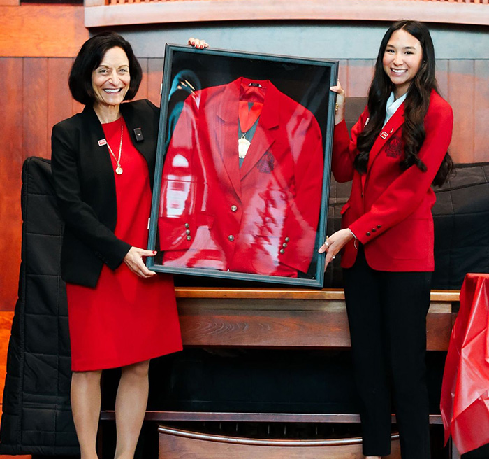 President Dahlberg receiving a red coat from the UTampa Diplomats