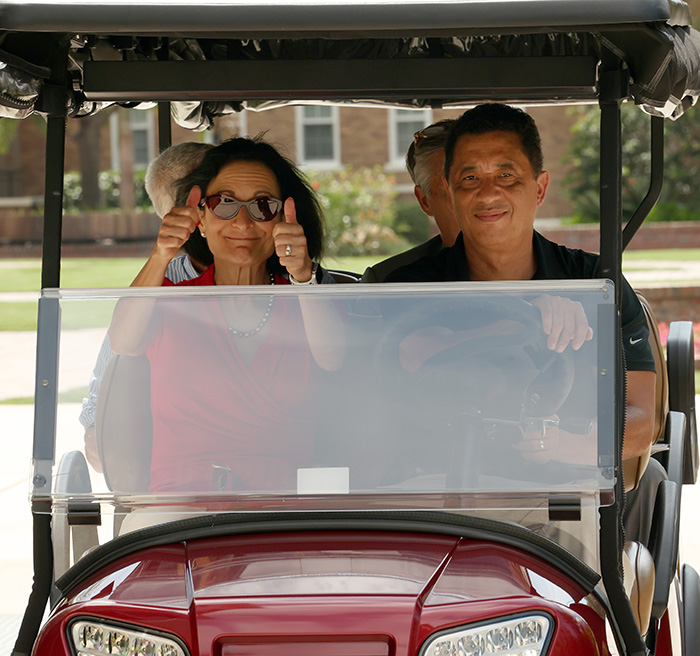 President Dahlberg riding in a golf cart
