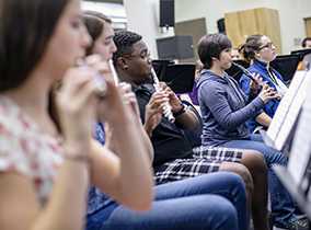 Students playing instruments Students in band class