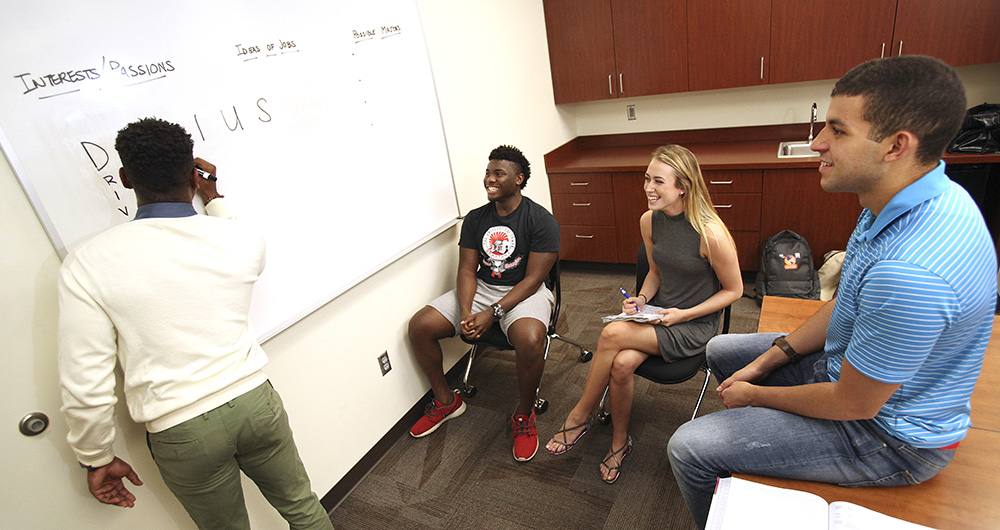 Student tutoring session in a classroom.
