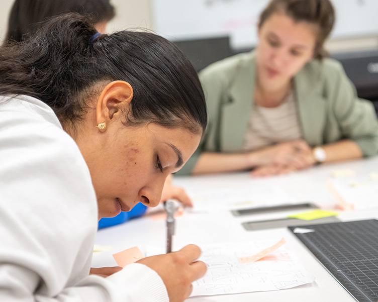 Student writing and working on an assignment.