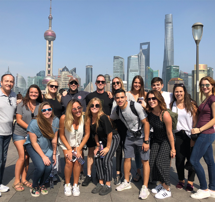 University of Tampa students posing in front of the China downtown skyline University of Tampa students posing in front of the China downtown skyline