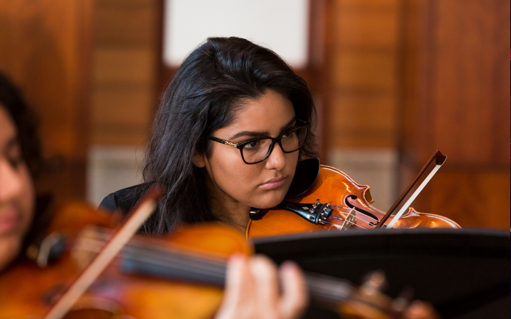 Student playing the violin Student playing the violin
