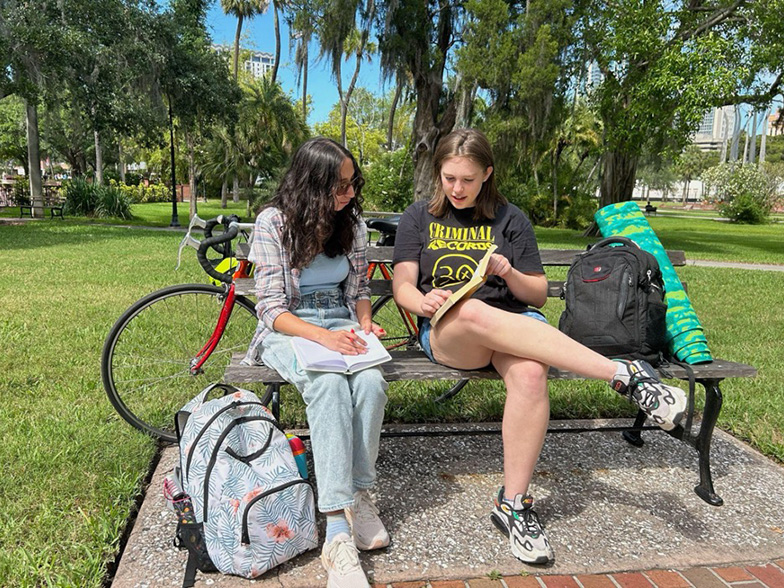 Students studying on a bench