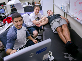 Students performing a sonogram on a muscle Students performing a sonogram on a muscle