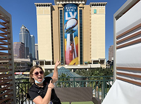 Students pointing at Super Bowl LV (55) banner Students pointing at Super Bowl LV (55) banner