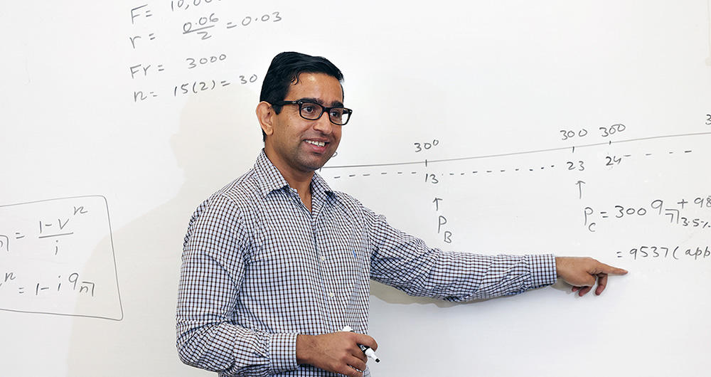 Professor teaching at a white board.