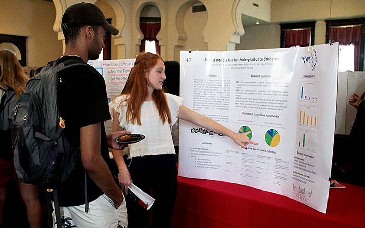 Student presenting poster at undergraduate research conference Visit UT Undergrad Callout