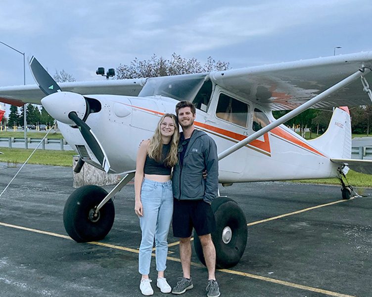 Student standing next to an airplane in Alaska.