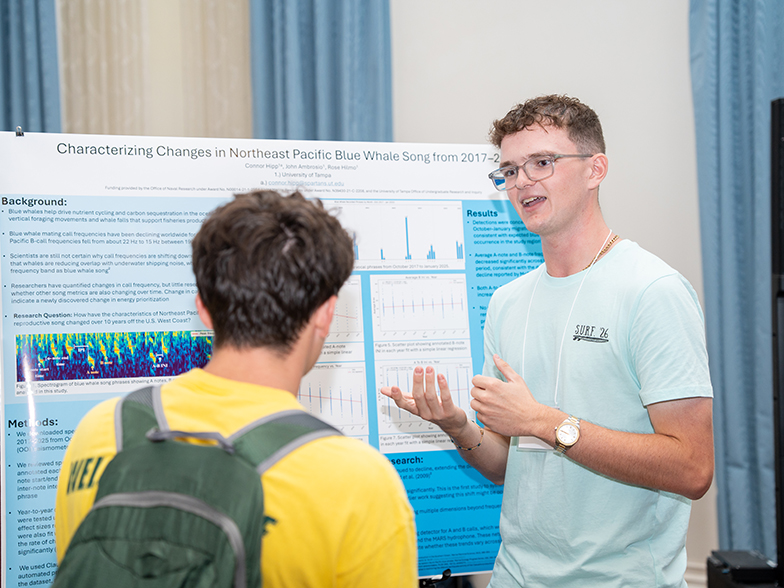 Student presenting a poster at SURF