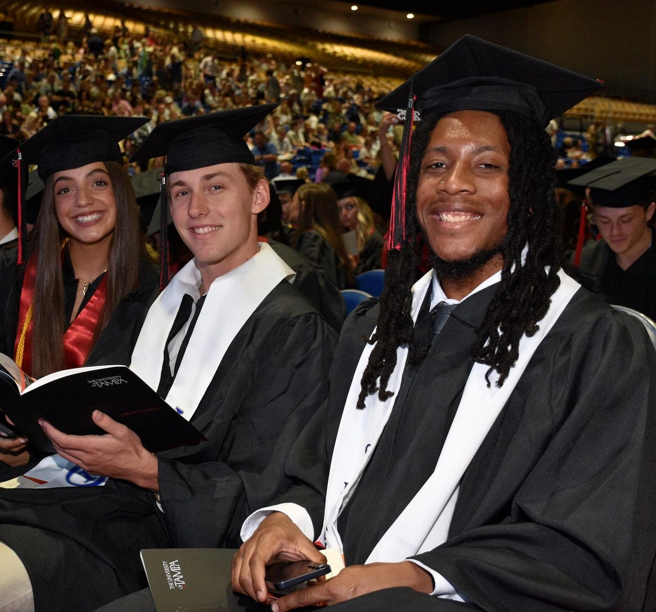 students in their caps and gowns at commencement