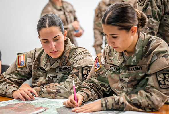 Two ROTC students working on a project.
