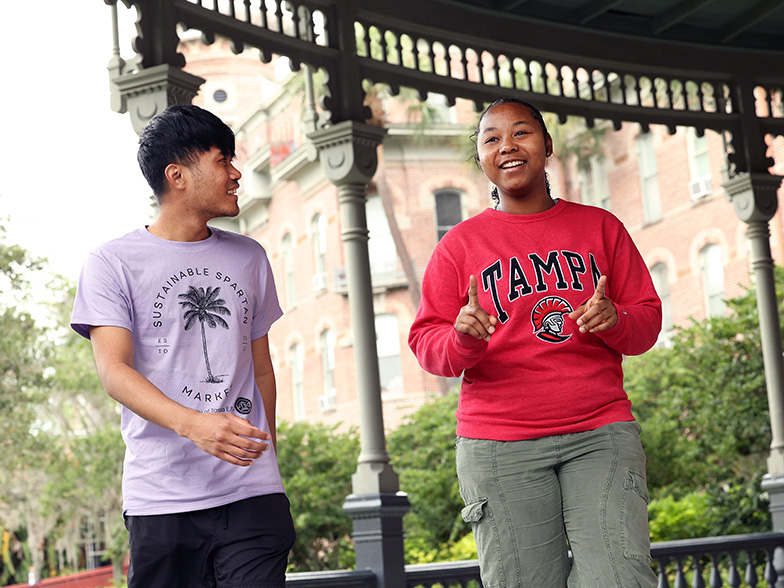 Two students walking on the Plant Hall verandah