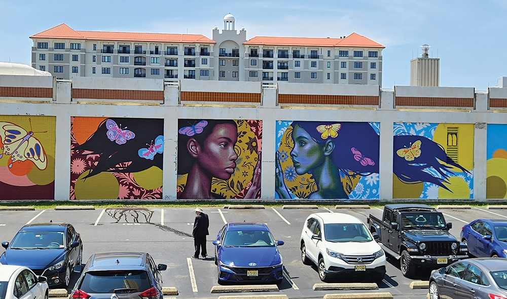 A large mural on a building split up by 5 pillars on a building 
