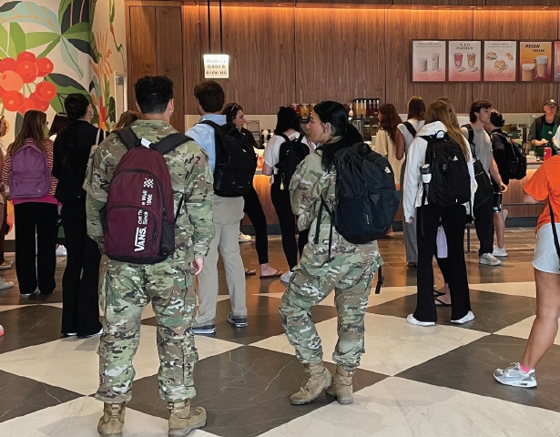 A CROWD WAITS ON THEIR ORDERS AT A COFFEE SHOP
