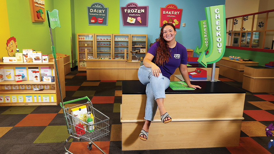 WOMAN SEATED ON COUNTER IN PLAY ROOM
