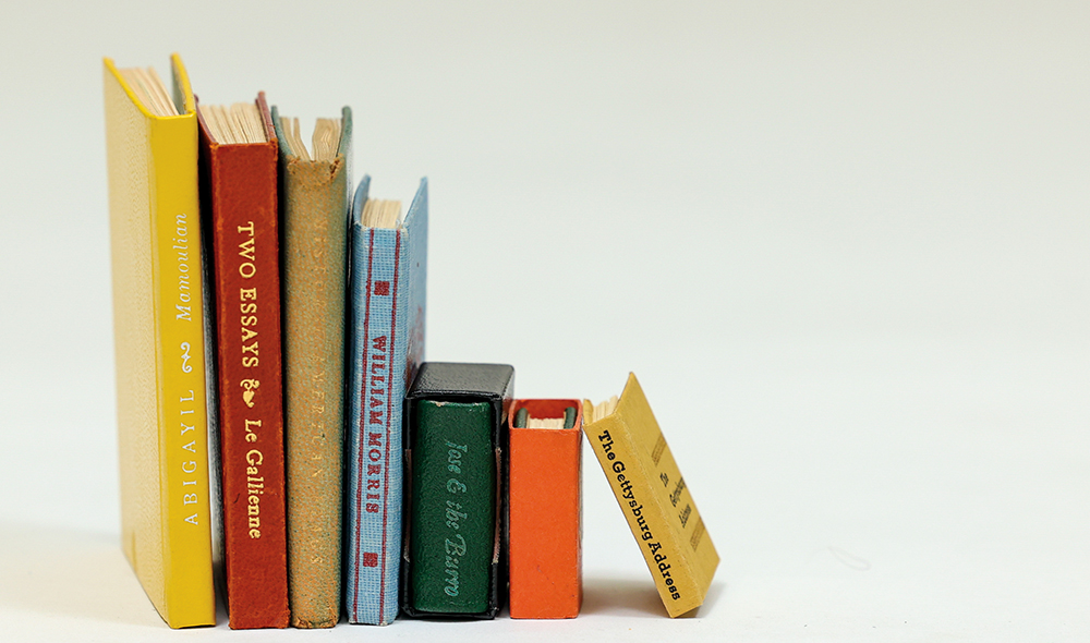 Several books arranged by size, tallest to smallest, from left to right