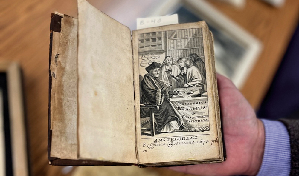 A tiny book opened to a page with a drawing on it.