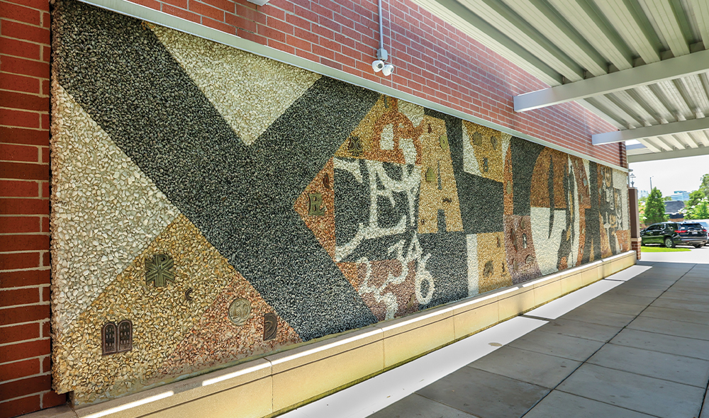 Abstract grey and brown mural made out of  tiny rocks
