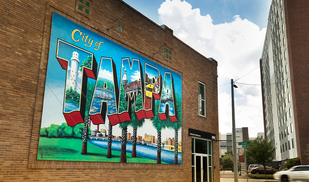 Mural painted to look like a postcard of tampa 