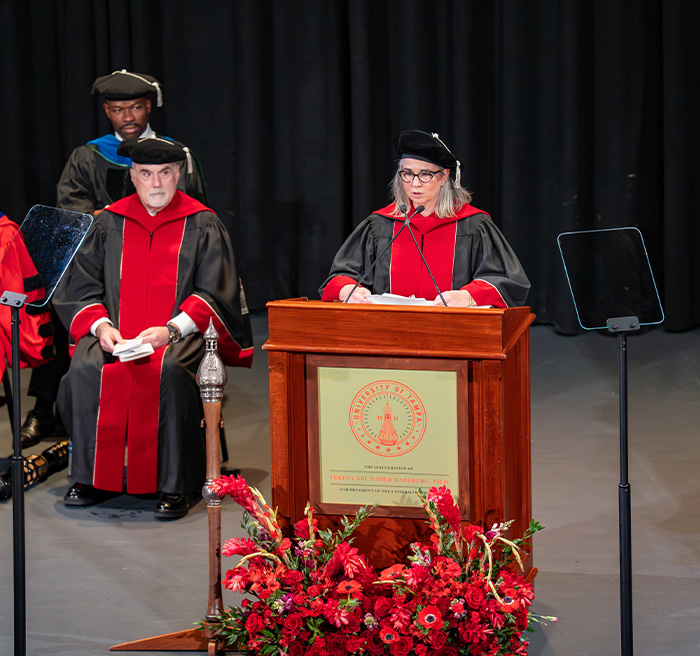 Professor reading a poem he wrote for the inauguration.