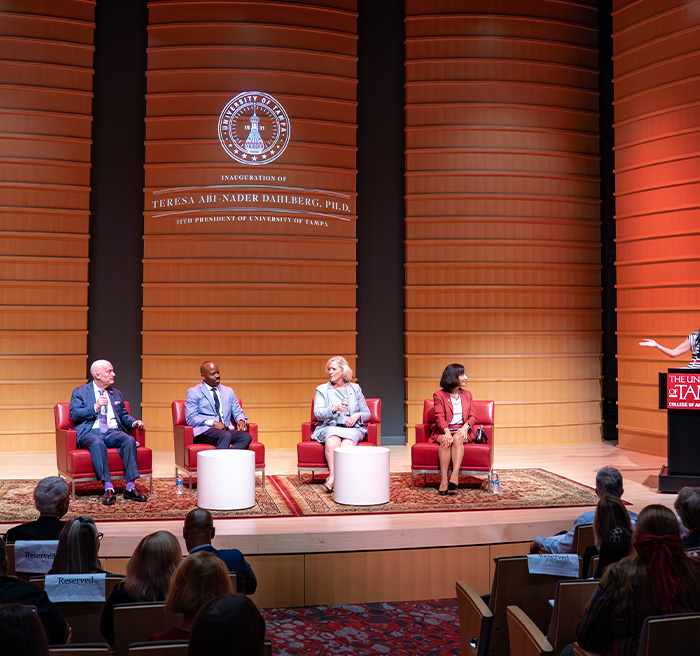 Dr. Dahlberg on stage at the Academic Symposium with two other university presidents: 