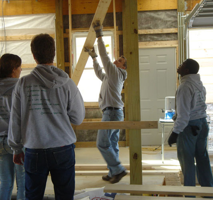 Students helping build a building