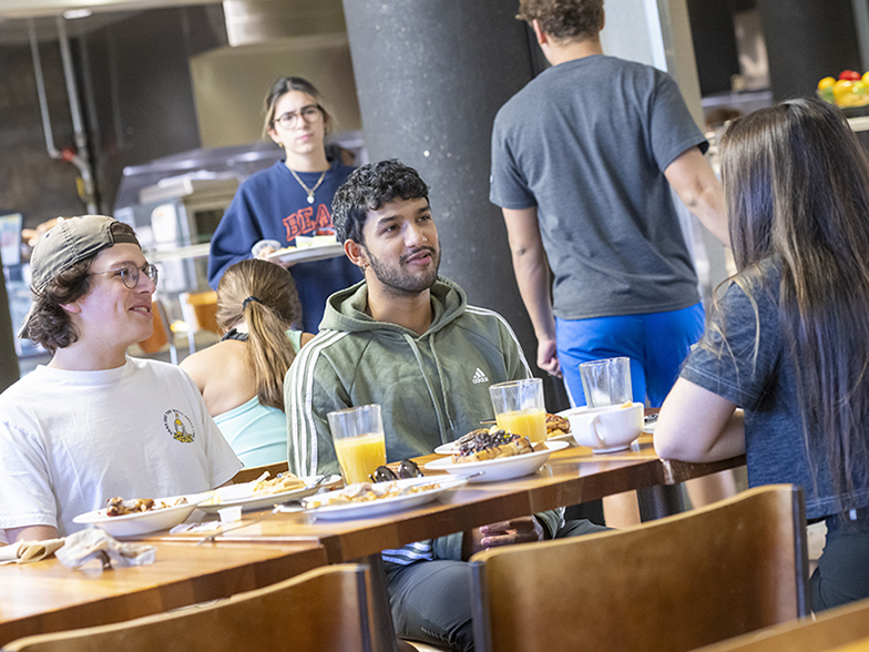 Students conversing over breakfast Students conversing over breakfast