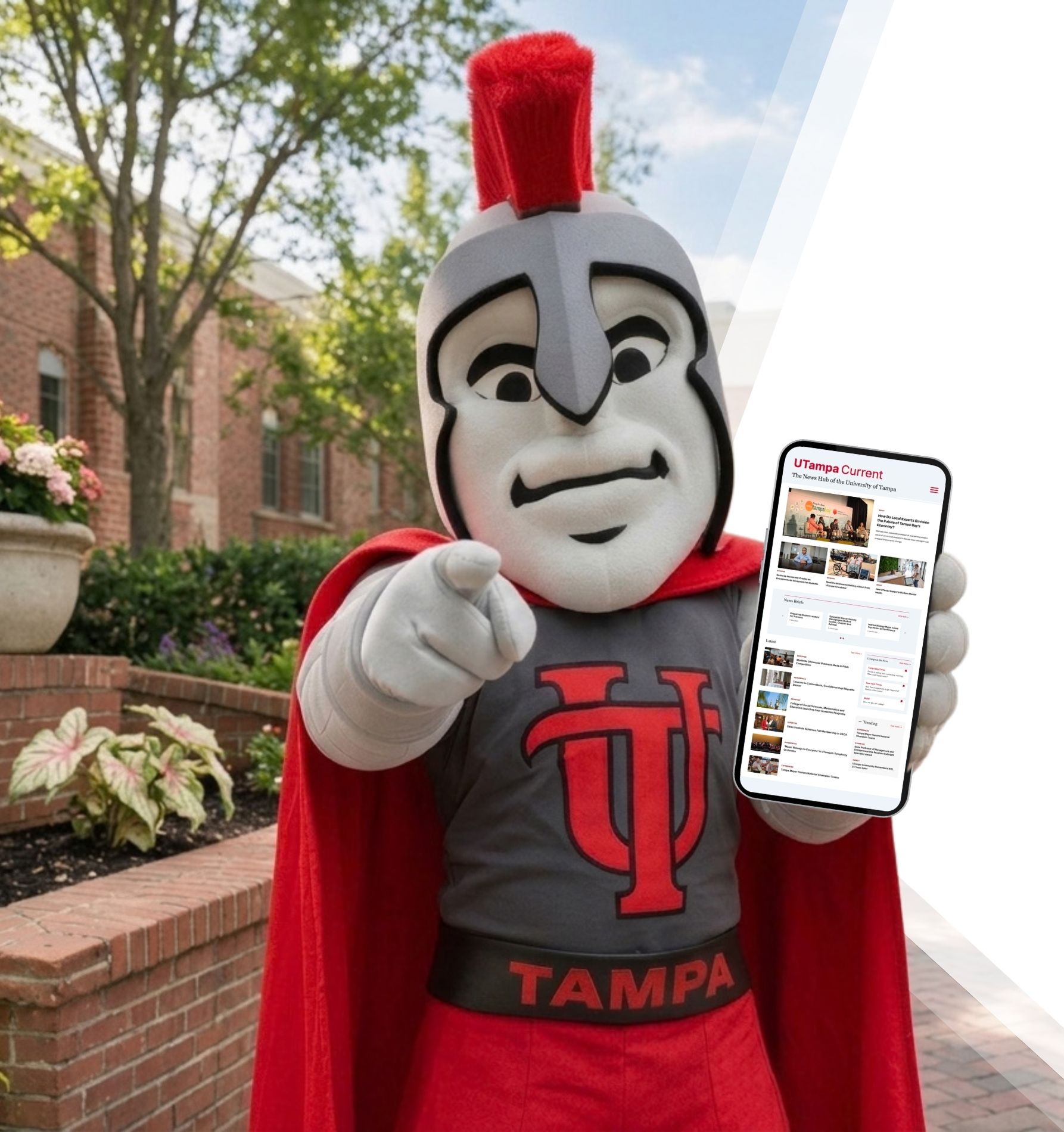 Spartacus holding a cell phone with the Current on the homepage.