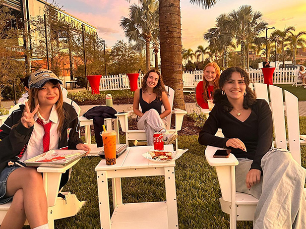Students hanging out at Armature Works by the river.