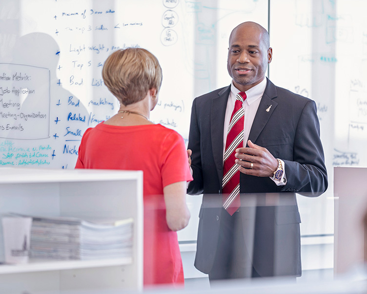 Dr. White talking with a LEC alumnus.