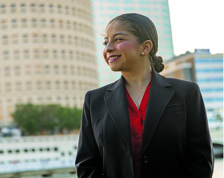 Students smiling with downtown Tampa in the background.