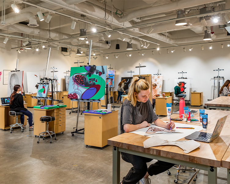 Art studio with students working on paintings