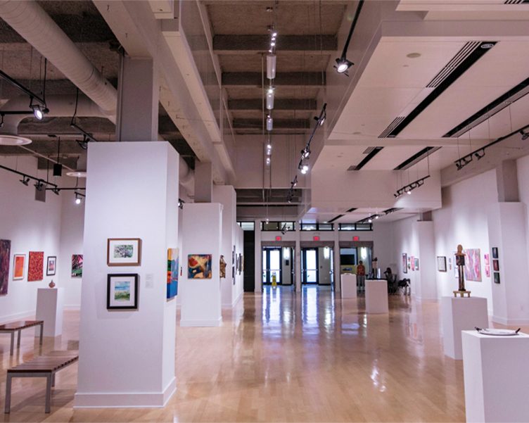 Art gallery with colorful paintings and sculptures on display