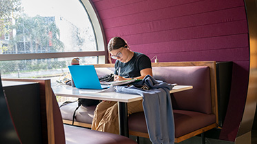 Student studying in the Grand Center.