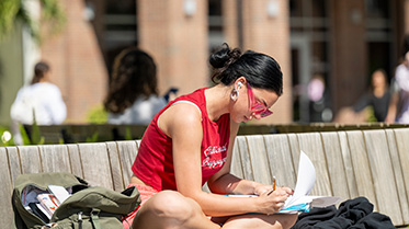 Student studying in the Ars Sonora plaza.
