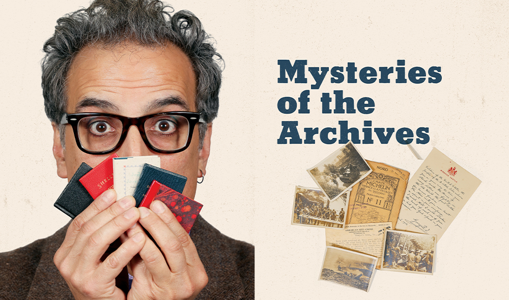 A man hold a fan of tiny books in front of this face