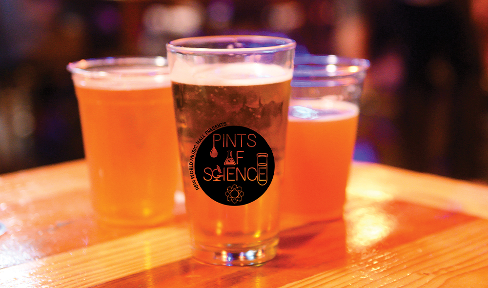 : A pint glass and two plastic cups filled with beer