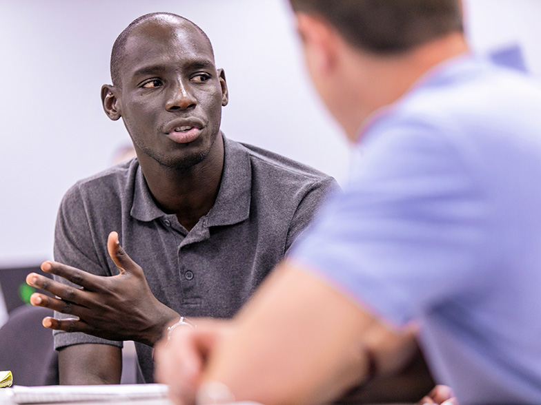 Two student talking during a business class.