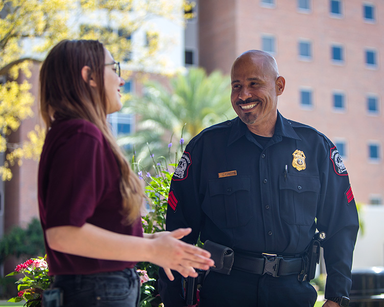 A Campus Safety officer interacts with a student.