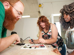 Three students working on animations