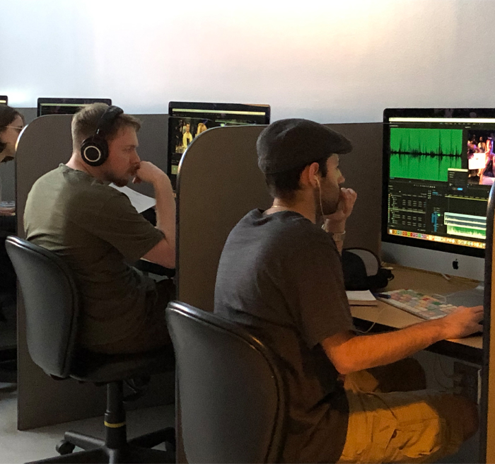 students editing on computers in computer lab 