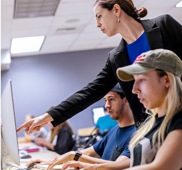 Professor and students at computers 