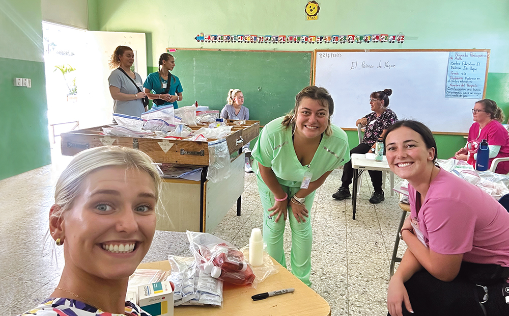 THREE WOMEN LOOK TOWARD THE CAMERA IN A MEDICAL CLINIC