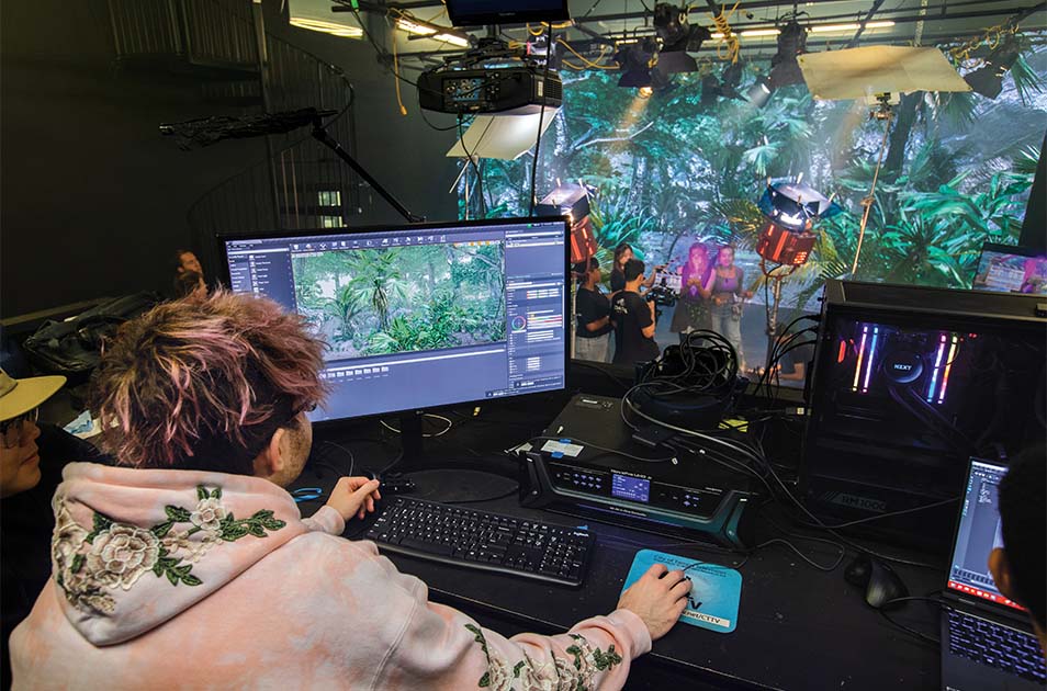 A student uses a 3D computer graphics application called Unreal Engine to create the scene on the screen.